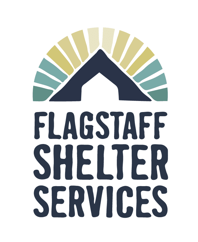Logo for Flagstaff Shelter Services featuring a stylized roof with multicolored rays above, symbolizing community support, and the organization’s name in bold letters below.